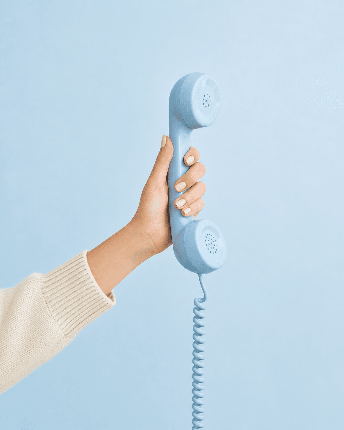 A hand holding a blue telephone receiver